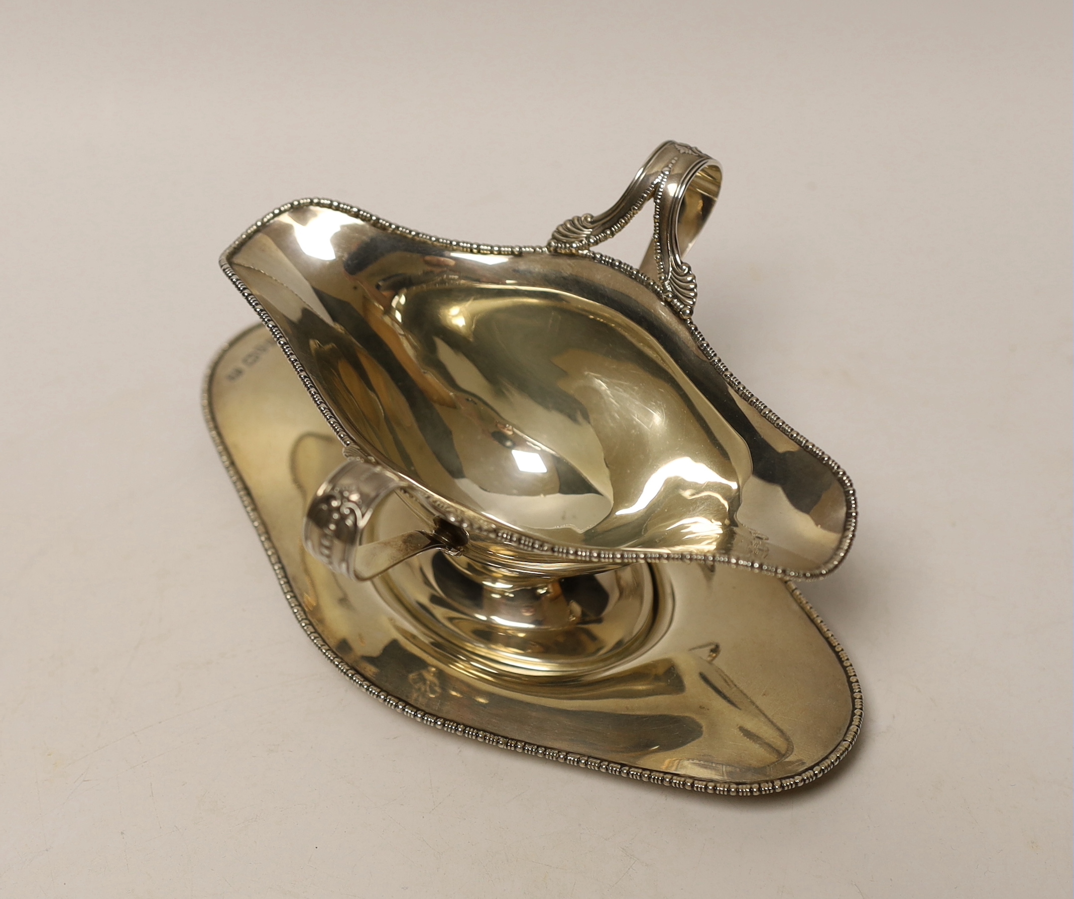 An Edwardian silver double lipped sauceboat and stand, Barker Brothers, Chester, 1907, stand 17.9cm, 6.4oz.